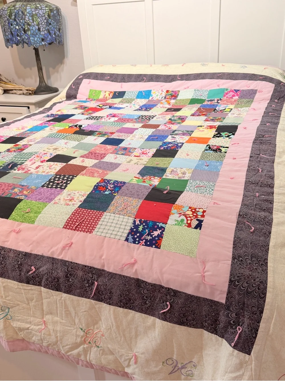 Hand crafted patchwork quilt with tan border